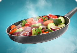 Steaming frying pan containing mixed vegetables including onion, carrots, courgettes and peppers.