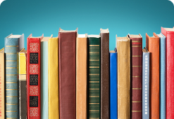 A shelf with a gap in the middle containing different sized books, spines facing us.