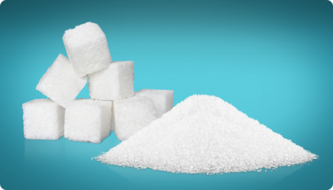 A pile of salt grains next to some sugar cubes.