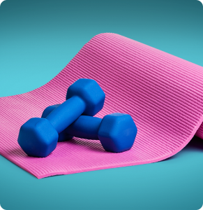 A purple yoga mat with two small blue dumbbell weights on top.