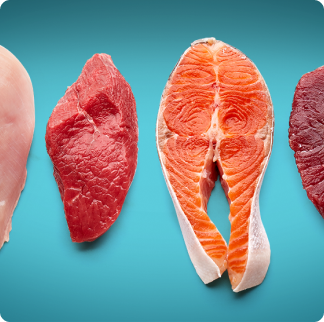 A selection of raw fillets of meat and fish, including chicken and salmon. 