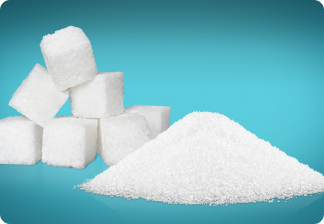 A pile of salt grains next to some sugar cubes.